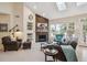 Living room with stone fireplace, vaulted ceilings, and bright windows at 4185 Cheyenne Dr, Larkspur, CO 80118