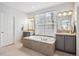 Large main bathroom features a soaking tub and dual sinks with vanities at 4185 Cheyenne Dr, Larkspur, CO 80118