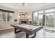Recreation area featuring a pool table next to the fireplace and sliding glass door to the patio at 4185 Cheyenne Dr, Larkspur, CO 80118