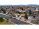 Expansive aerial view captures a cozy neighborhood with a charming single-story home with a landscaped front yard at 11397 Kendall St, Westminster, CO 80020