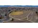 Expansive aerial view showcasing the community park and walking paths with mountain views at 11397 Kendall St, Westminster, CO 80020