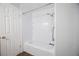 Bathroom featuring a white bathtub and shower with white tiled walls and a shower head at 11397 Kendall St, Westminster, CO 80020