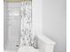 Full bathroom with shower, toilet, and floral shower curtain at 11397 Kendall St, Westminster, CO 80020