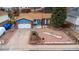 Aerial view of a well-maintained blue single-story home with a two-car garage and lovely front yard at 11397 Kendall St, Westminster, CO 80020