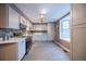 Bright kitchen features white cabinets, a tiled backsplash, stainless steel appliances, and hardwood floors at 11397 Kendall St, Westminster, CO 80020