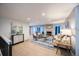 Bright living room with stone fireplace, modern furniture, light-colored wood floors and recessed lighting at 11397 Kendall St, Westminster, CO 80020
