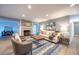 Comfortable living area boasts wood floors, recessed lights, stylish decor, and a cozy fireplace at 11397 Kendall St, Westminster, CO 80020