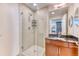 Bathroom featuring a glass-enclosed shower and dark granite countertops at 891 14Th St # 2002, Denver, CO 80202