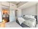 Comfortable bedroom featuring a view into the kitchen and a large window with natural light at 891 14Th St # 2002, Denver, CO 80202