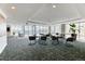 Bright common area with tables, comfortable seating, and expansive windows offering city views at 891 14Th St # 2002, Denver, CO 80202