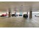 Spacious, secure parking garage showcasing multiple parking spots and a variety of vehicles at 891 14Th St # 2002, Denver, CO 80202