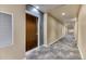 Well-lit hallway with neutral decor and stylish carpeting at 891 14Th St # 2002, Denver, CO 80202