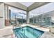Rooftop hot tub with blue tiles, stainless steel ladder, and amazing city views through glass enclosure at 891 14Th St # 2002, Denver, CO 80202