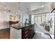 Open floor plan showcasing the kitchen island and living room with large windows and city views at 891 14Th St # 2002, Denver, CO 80202