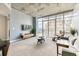 Inviting condo living room filled with natural light, city views, and stylish modern furniture at 891 14Th St # 2002, Denver, CO 80202