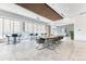 Open recreation room with a long dining table, seating, and large windows allowing for plenty of natural light at 891 14Th St # 2002, Denver, CO 80202