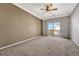 Bright bedroom featuring a sliding glass door to balcony at 9451 Ashbury Cir # 202, Parker, CO 80134