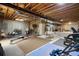 Unfinished basement with exposed ceiling, exercise equipment, and painted walls at 8068 Dressage Rd, Littleton, CO 80125