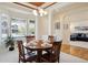 A dining room with a wooden table, four chairs, and a large window that provides a view of the neighborhood at 8068 Dressage Rd, Littleton, CO 80125
