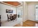 Bright dining room showcasing elegant lighting, bay windows, and an adjacent entry foyer at 8068 Dressage Rd, Littleton, CO 80125