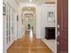 Bright hallway featuring hardwood floors, arched doorways, and neutral paint scheme at 8068 Dressage Rd, Littleton, CO 80125
