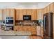 A kitchen with custom cabinets, granite countertops, stainless steel appliances, and a center island at 8068 Dressage Rd, Littleton, CO 80125