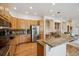A kitchen with custom cabinets, granite countertops, stainless steel appliances, and a center island at 8068 Dressage Rd, Littleton, CO 80125