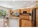 A kitchen with custom cabinets, granite countertops, stainless steel appliances, and an island with seating at 8068 Dressage Rd, Littleton, CO 80125
