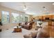 A living room features sofas, a coffee table, and large windows with a view of the outside at 8068 Dressage Rd, Littleton, CO 80125