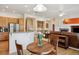 Bright living room featuring hardwood floors, a cozy fireplace, and an open layout connecting to the kitchen at 8068 Dressage Rd, Littleton, CO 80125