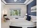 Relaxing main bedroom featuring natural light, stylish decor, and a comfortable king-sized bed at 8068 Dressage Rd, Littleton, CO 80125