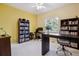 Dedicated office space with built-in bookshelves and a large window allowing for plenty of natural light at 8068 Dressage Rd, Littleton, CO 80125