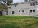 Spacious backyard featuring a lush lawn, shed, and the exterior of the home with sliding glass doors and windows at 11427 Brownstone Dr, Parker, CO 80138