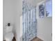 Bathroom featuring toilet, floral shower curtain, and window for natural light at 11427 Brownstone Dr, Parker, CO 80138