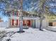 Inviting home with snow-covered lawn, red shutters, and a cozy porch at 11427 Brownstone Dr, Parker, CO 80138