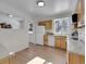 Open kitchen design with wood cabinets, white appliances, and an eat-in area at 11427 Brownstone Dr, Parker, CO 80138