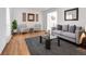 Cozy living room featuring stylish furniture, light wood floors, neutral decor, and an adjacent room at 11427 Brownstone Dr, Parker, CO 80138