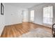Bright and airy living room with hardwood floors, sheer curtains, and white walls creating a fresh and modern feel at 11427 Brownstone Dr, Parker, CO 80138