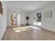 Large living room showcasing a sliding glass door, neutral walls, and wood flooring at 11427 Brownstone Dr, Parker, CO 80138