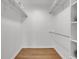 Walk-in closet featuring hanging racks and wooden floor at 11427 Brownstone Dr, Parker, CO 80138