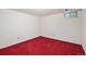 Unfinished basement with red carpet and one small window providing natural light at 3274 S Heather Gardens Way, Aurora, CO 80014
