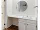 Bathroom with wood-look floors, a vanity and toilet, plus a mirror at 3274 S Heather Gardens Way, Aurora, CO 80014