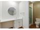 Bathroom features a sink and vanity, toilet, and a glass shower stall at 3274 S Heather Gardens Way, Aurora, CO 80014