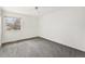 Carpeted bedroom with a ceiling fan and a large window with backyard views at 3274 S Heather Gardens Way, Aurora, CO 80014