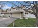 Inviting home exterior showcasing a two-car garage and lush green yard at 3274 S Heather Gardens Way, Aurora, CO 80014