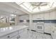 Bright kitchen with marble floors, white cabinetry, and modern appliances at 3274 S Heather Gardens Way, Aurora, CO 80014