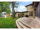 Landscaped backyard with a stone patio, green lawn, and play area, creating a perfect space for outdoor enjoyment at 1351 S Milwaukee St, Denver, CO 80210