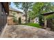 Beautiful backyard featuring a stone patio, lush lawn, and a play structure, perfect for Gathering fun at 1351 S Milwaukee St, Denver, CO 80210
