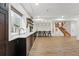 Wide view of the basement bar, with barstool seating, and access to the stairs at 1351 S Milwaukee St, Denver, CO 80210