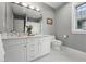 Bathroom features dual sinks with marble counters, white cabinets, and hexagon tile floors at 1351 S Milwaukee St, Denver, CO 80210